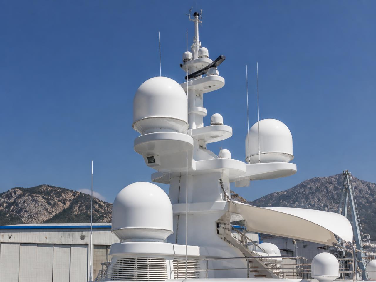 Superyacht mast with satellite radomes at a Mediterranean refit yard